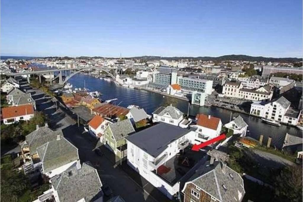 an aerial view of a city with a river and buildings at Apartment close to Aibel Haugesund in Haugesund