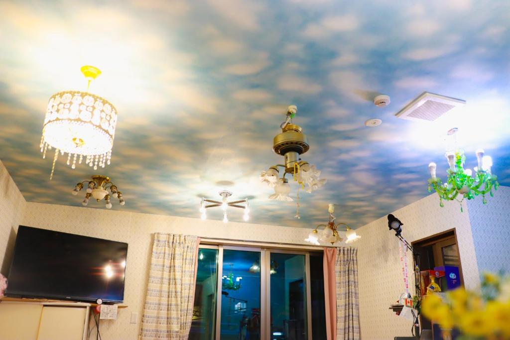 a room with a ceiling with clouds painted on it at Tokyo Guest House 2020 in Tokyo