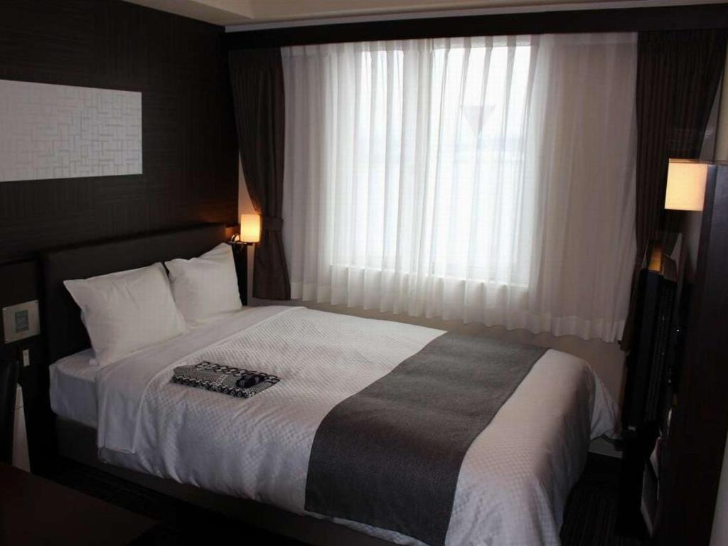 Postel nebo postele na pokoji v ubytování Matsue New Urban Hotel