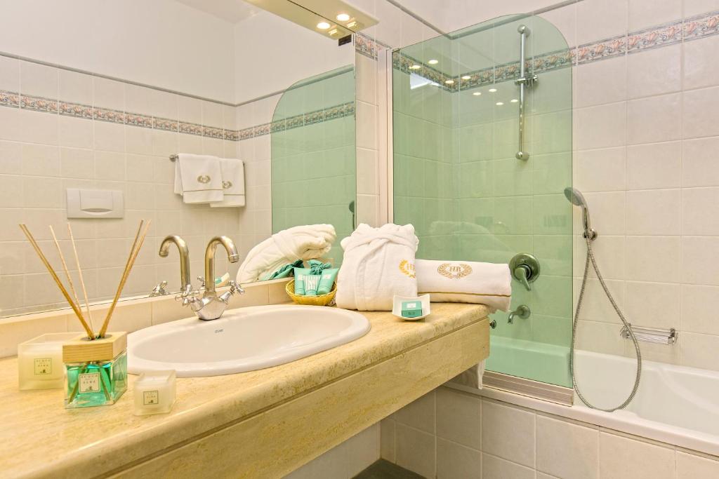 a bathroom with a sink and a shower at Hotel Biodola in Portoferraio