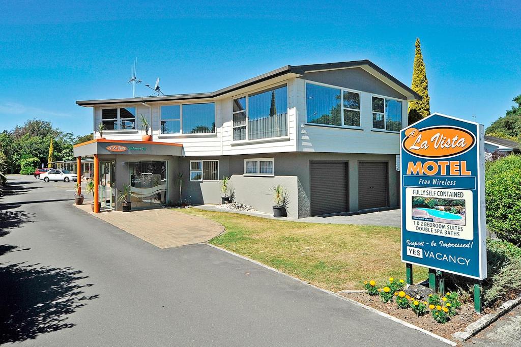 a motel sign in front of a house at A'La Vista Motel in Palmerston North