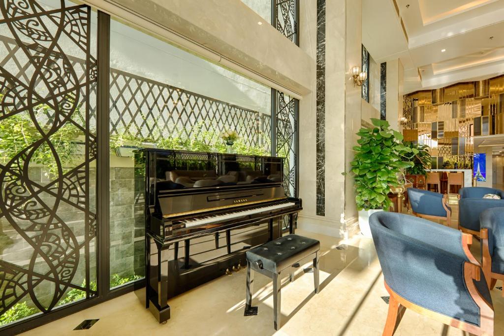 A sunlit lobby corner centered on an upright piano.