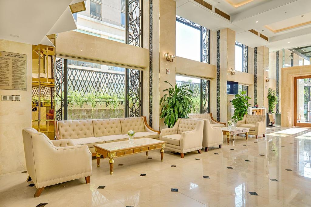 A quieter lobby seating area beside tall windows and the entrance.