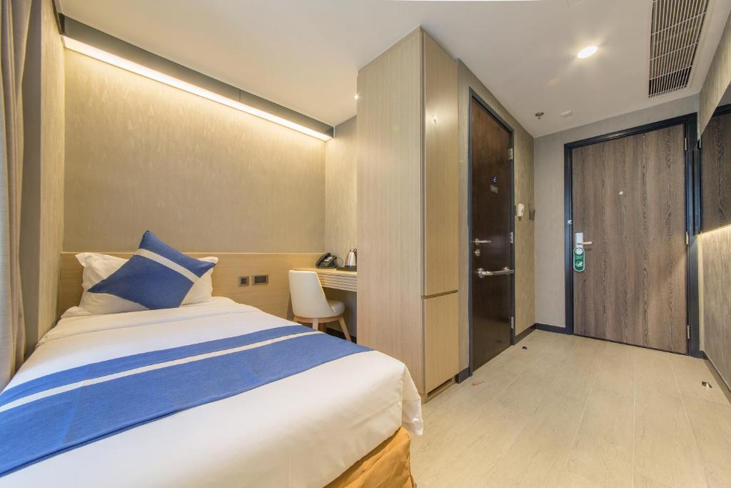 A bed or beds in a room at Lumine Hotel