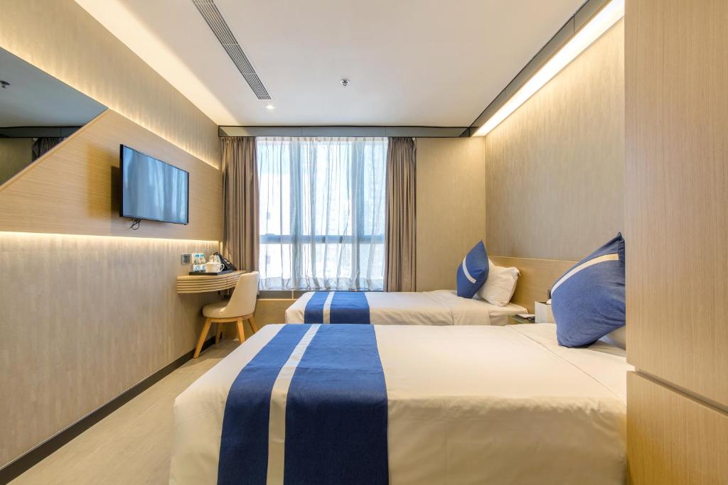 A bed or beds in a room at Lumine Hotel