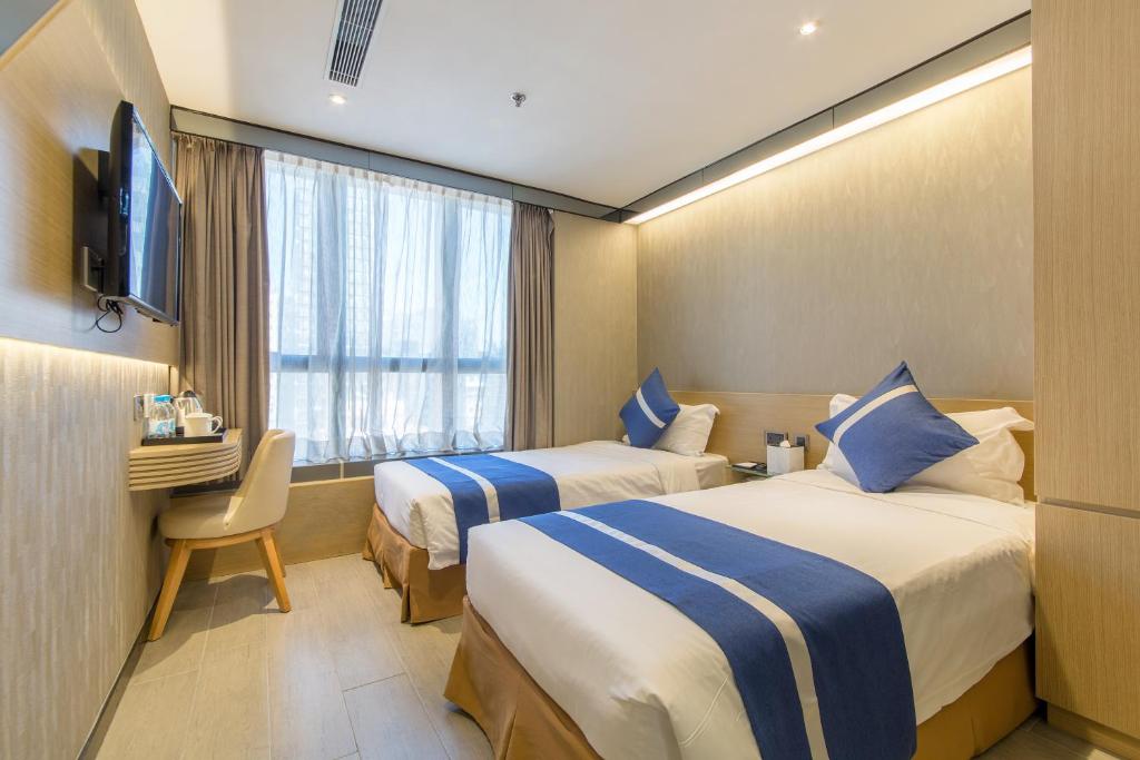 A bed or beds in a room at Lumine Hotel