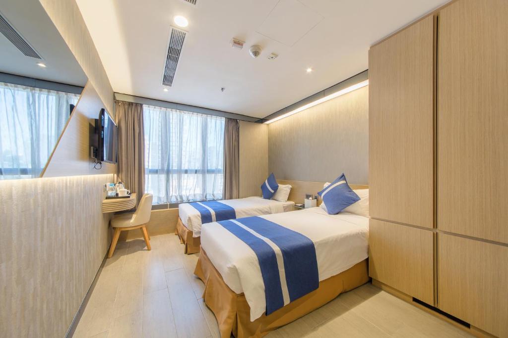 A bed or beds in a room at Lumine Hotel