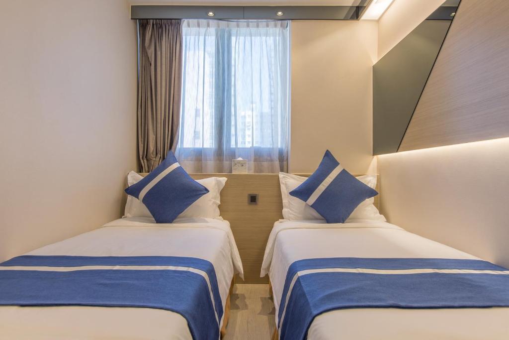 A bed or beds in a room at Lumine Hotel