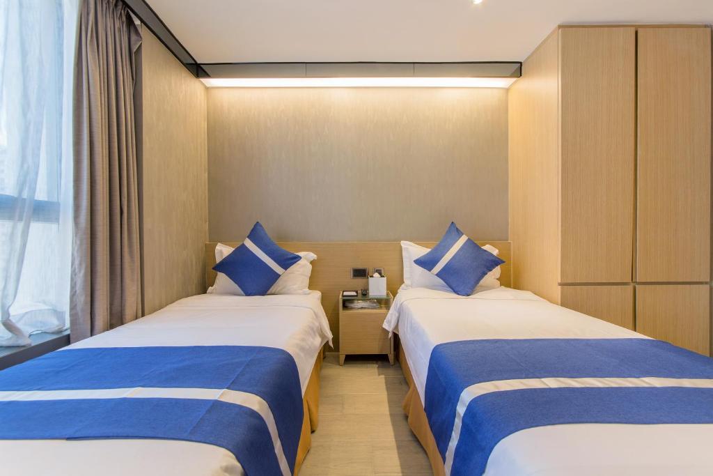 A bed or beds in a room at Lumine Hotel