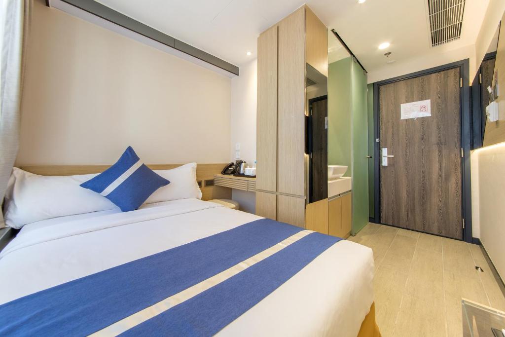 A bed or beds in a room at Lumine Hotel
