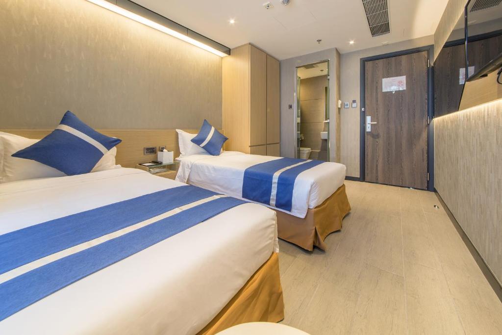 A bed or beds in a room at Lumine Hotel