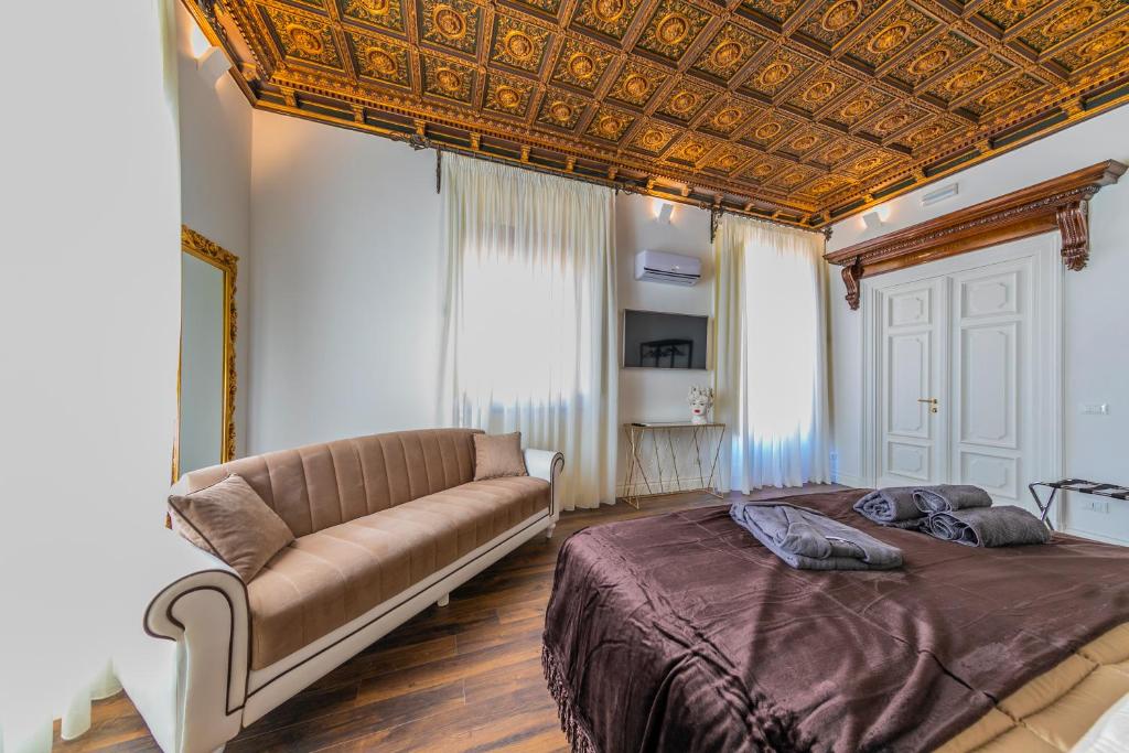 Łóżko lub łóżka w pokoju w obiekcie Palazzo Ardizzone
