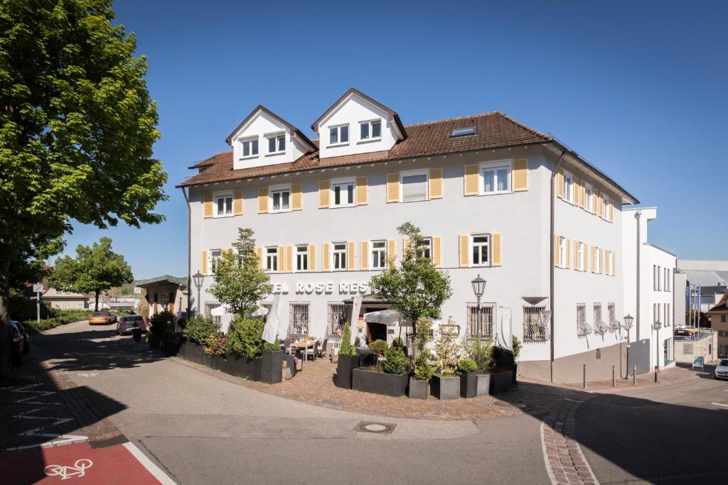 un grand bâtiment blanc sur le côté d'une rue dans l'établissement Hotel & Restaurant Rose, à Bietigheim-Bissingen