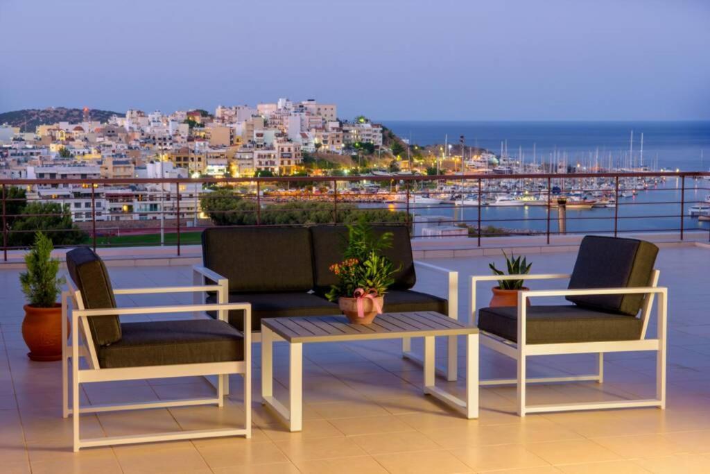 two chairs and a table on a balcony with a view at Gargadoros House in Agios Nikolaos