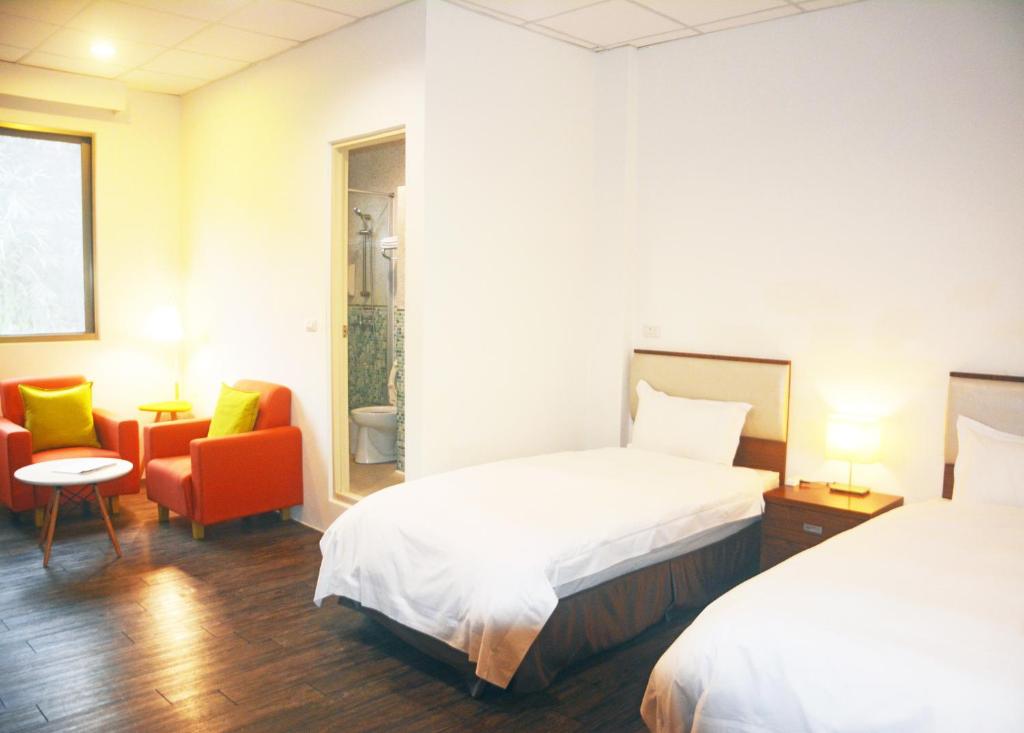 Postel nebo postele na pokoji v ubytování NCNU Campus Inn暨大行旅