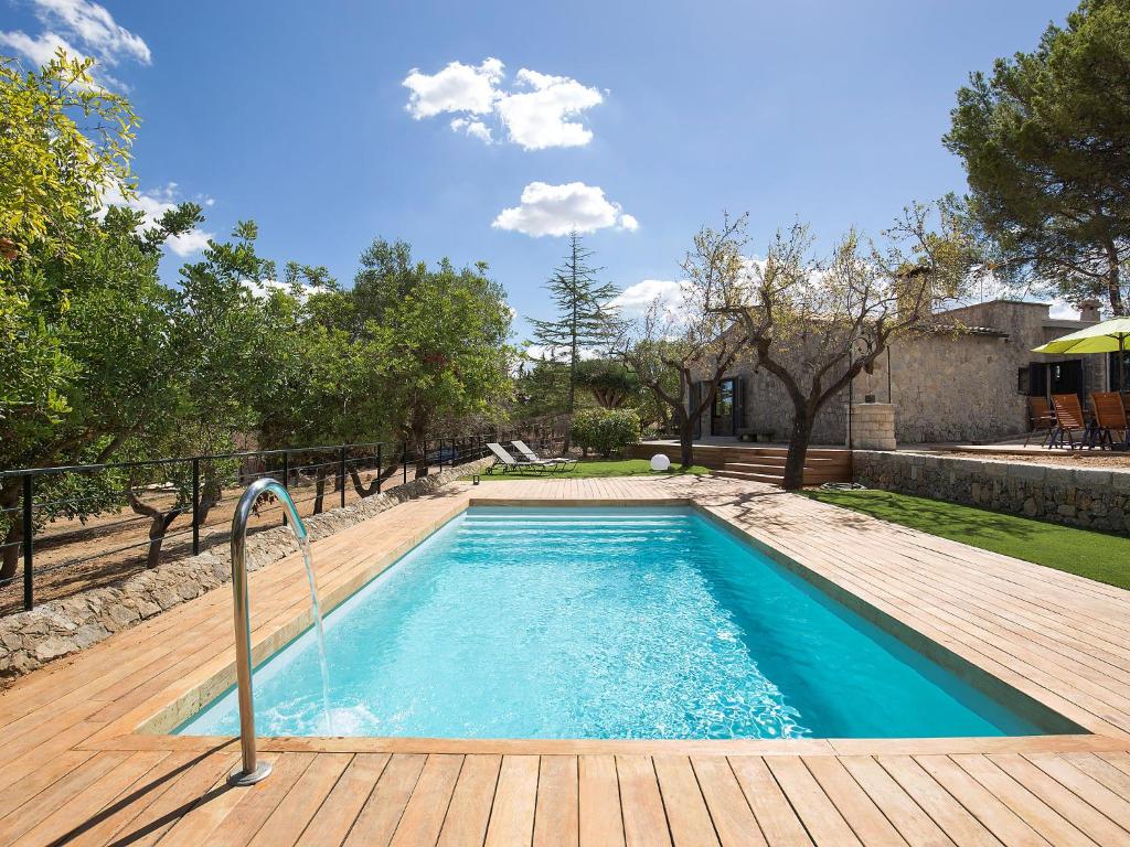 a swimming pool with a hose in a yard at Holiday Home Can Coll by Interhome in Inca