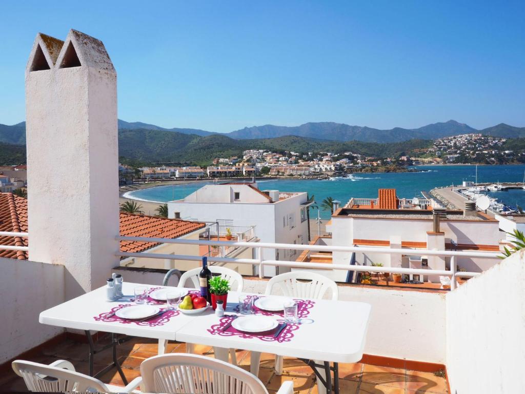 a white table and chairs on a balcony with a view at Apartment Roger de Flor-1 by Interhome in Llança