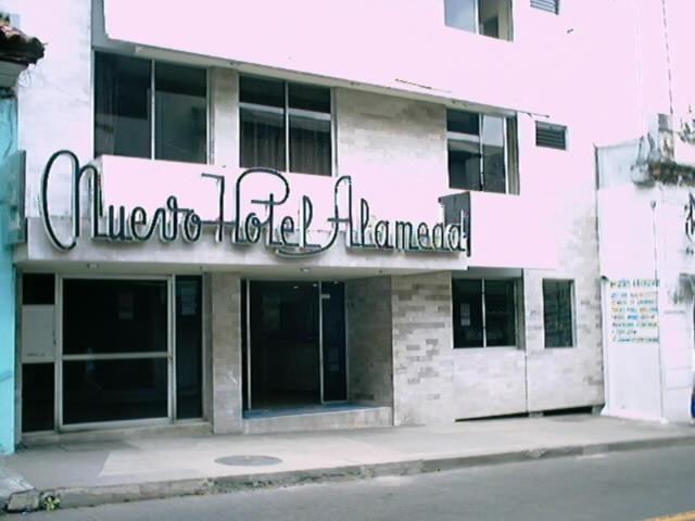 a building with a sign on the side of it at Nuevo Hotel Alameda de Uruapan in Uruapan del Progreso