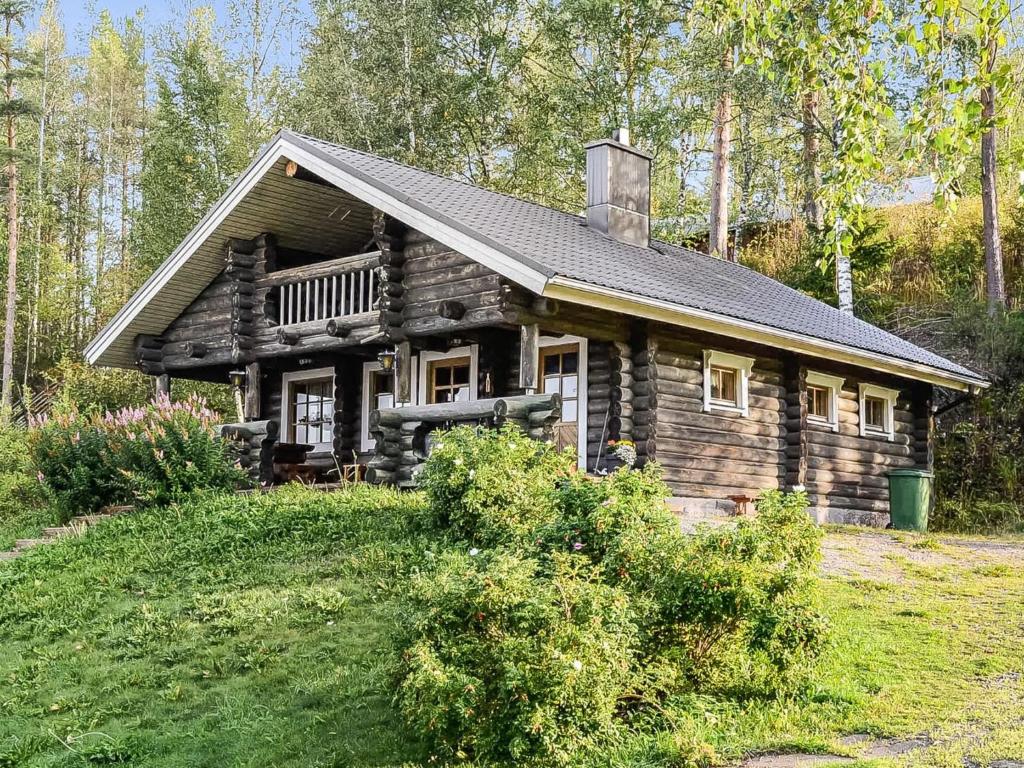 a log cabin in the middle of a field at Holiday Home Savilahti by Interhome in Ahmovaara