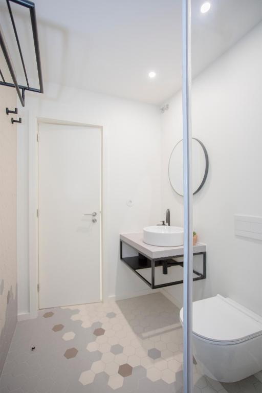 a bathroom with a toilet and a sink at Liiiving in Porto - Luxury Beachfront Apartments in Porto