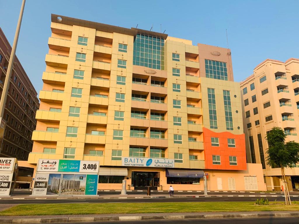 ein großes Gebäude mitten in einer Straße in der Unterkunft Baity Hotel Apartments in Dubai