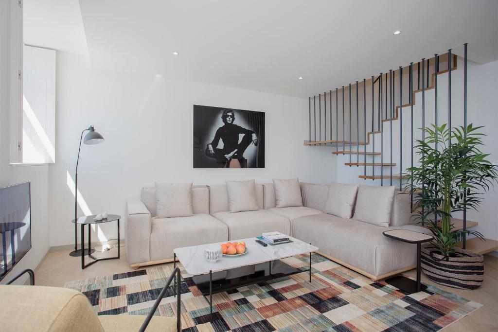 a living room with a couch and a table at Liiiving in Porto - Luxury Beachfront Apartments in Porto