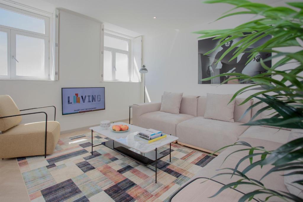 a living room with a couch and a coffee table at Liiiving in Porto - Luxury Beachfront Apartments in Porto