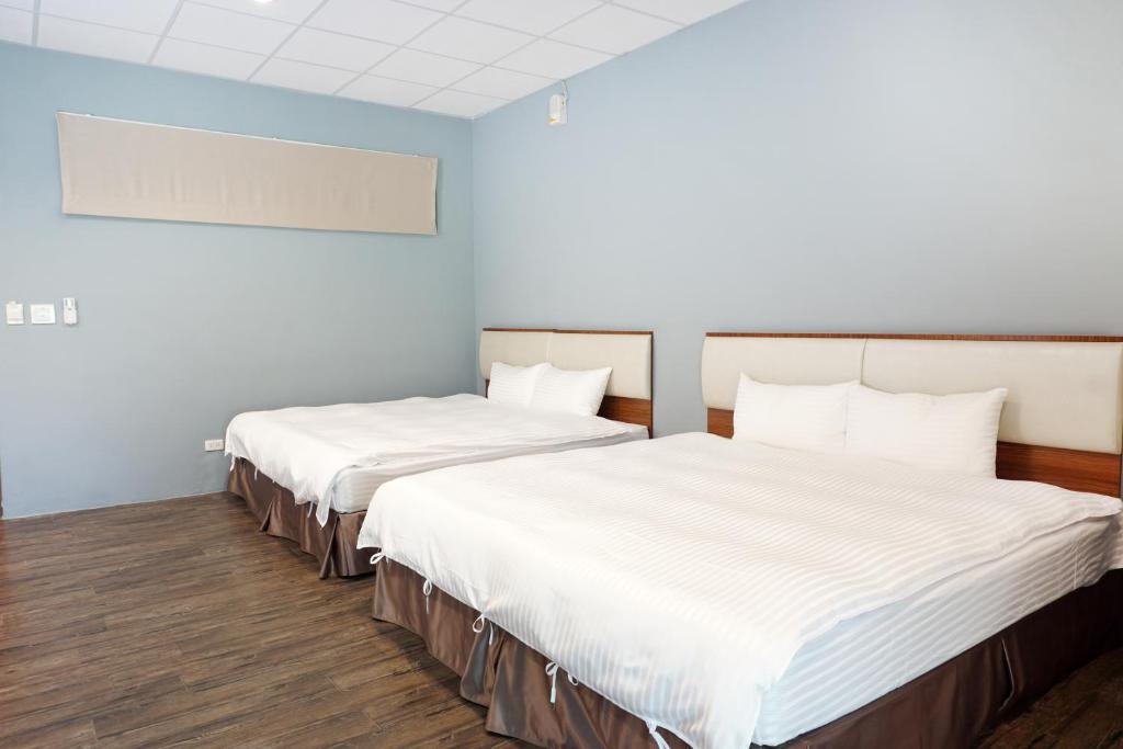 Postel nebo postele na pokoji v ubytování NCNU Campus Inn暨大行旅