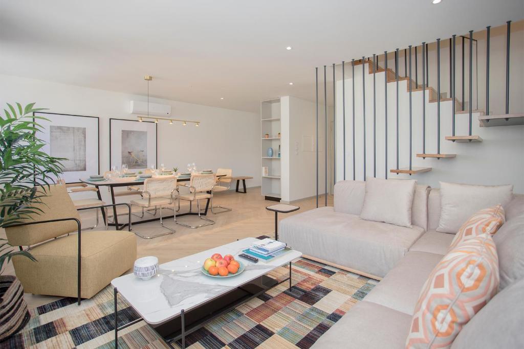 a living room with a couch and a table at Liiiving in Porto - Luxury Beachfront Apartments in Porto