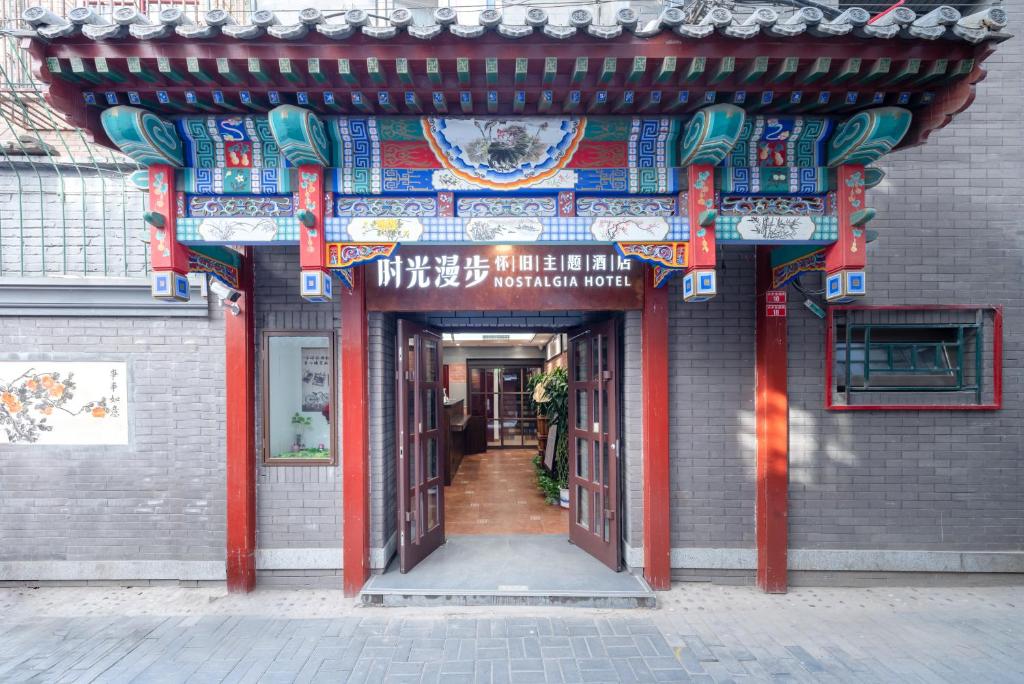 une entrée dans un bâtiment rouge et bleu dans l'établissement Nostalgia Hotel Beijing - Tian'anmen Square, à Pékin