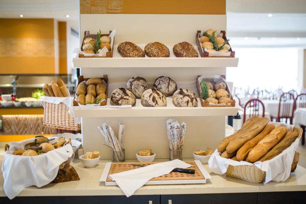a bakery with shelves filled with bread and pastries at HL Suitehotel Playa del Inglés - Adults Only in Playa del Ingles