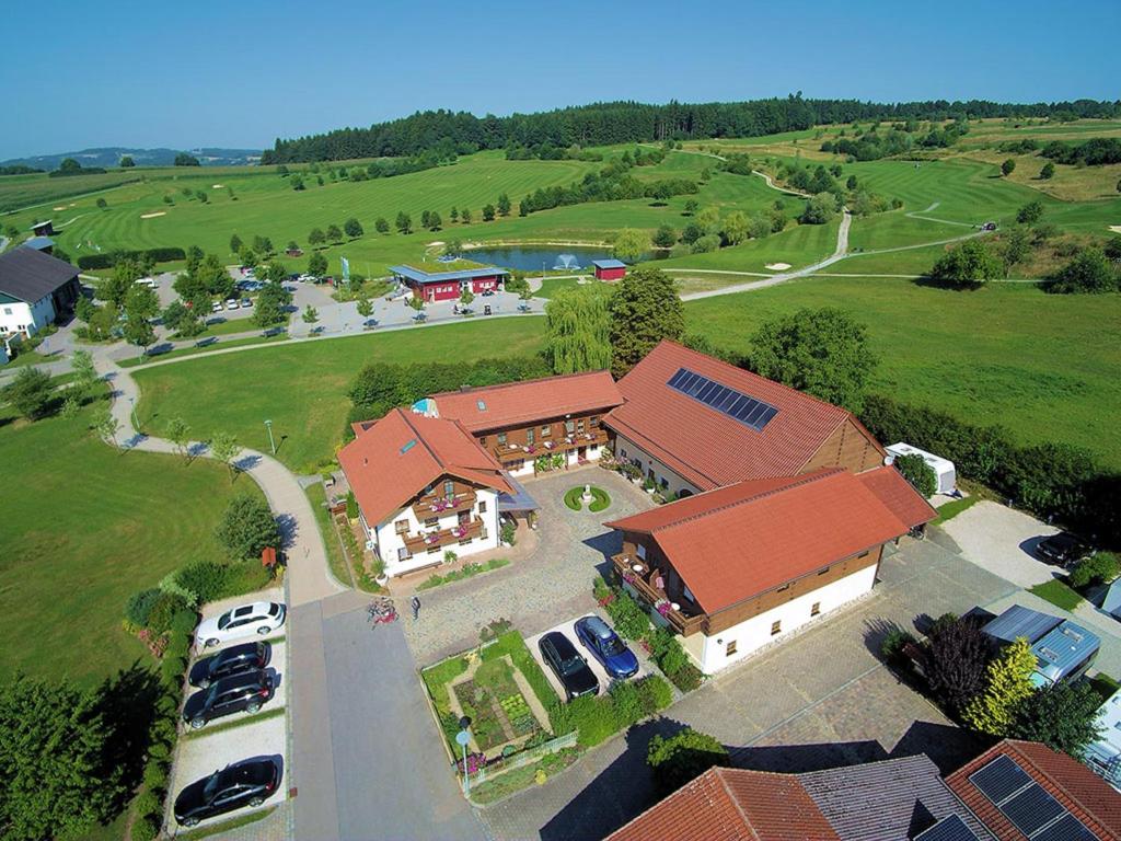 an overhead view of a large house with cars parked in front at Boutique-Hotel Hasenberger in Bad Birnbach