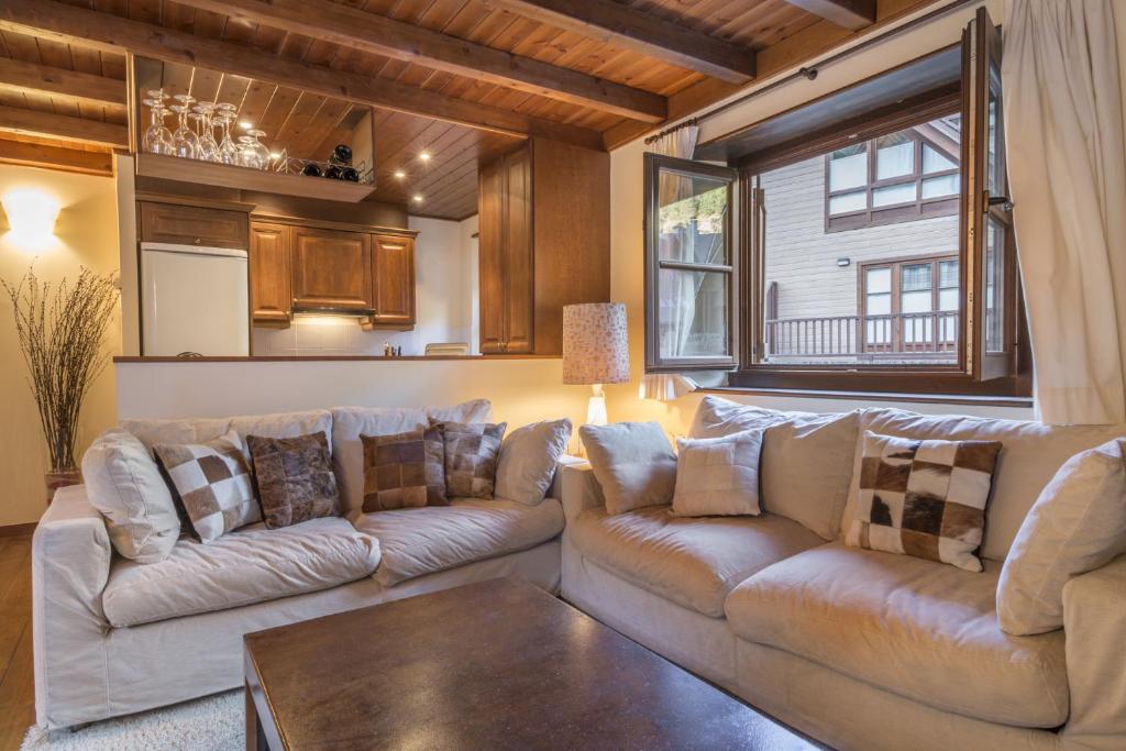 a living room with two couches and a table at Jireta by Totiaran in Barruera