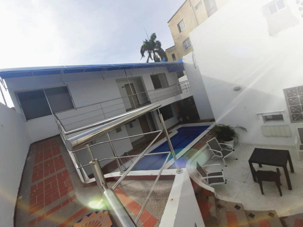 a balcony of a building with a staircase and a table at Villa Mary Hostal in Barranquilla