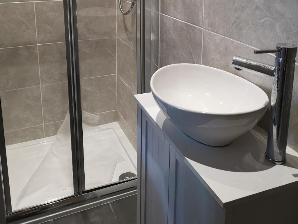 a bathroom with a sink and a shower at Beside the Bay in Millport