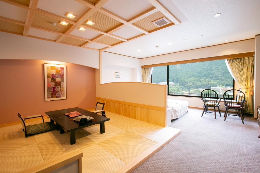 a living room with a dining room table and chairs at Sasara in Gero