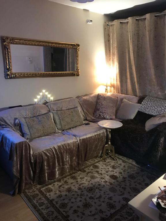 a living room with a couch and a table at Laundry Cottage Apartments in Southampton