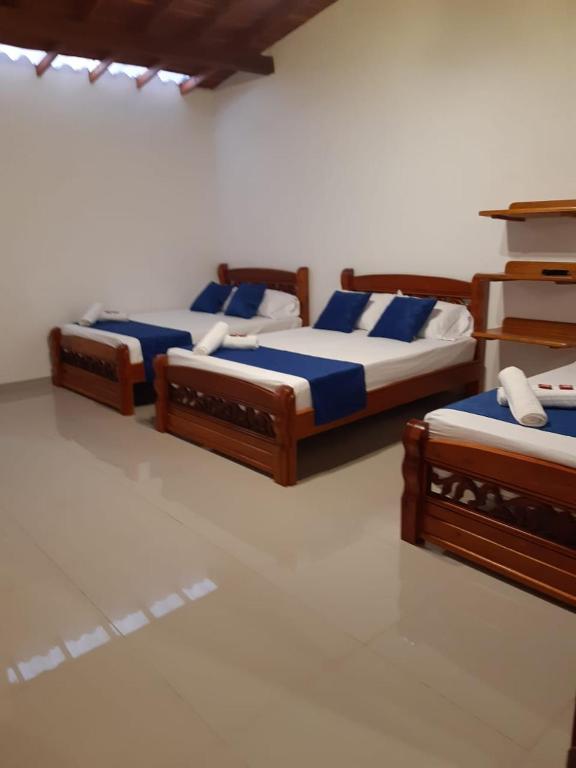 Postel nebo postele na pokoji v ubytování Hotel Jardín de Rosas