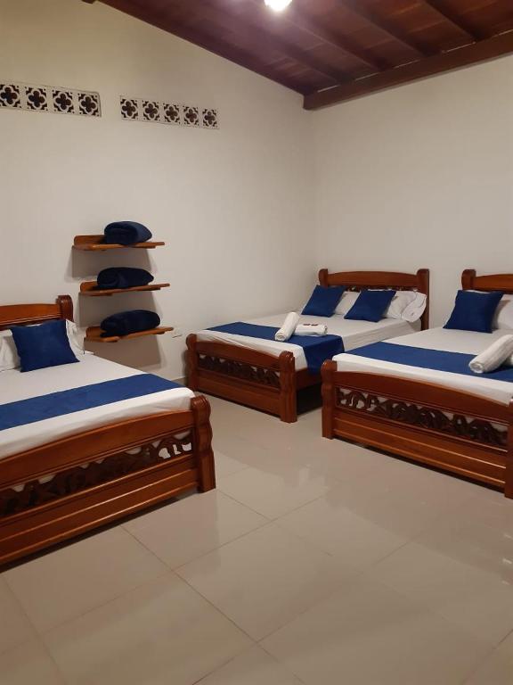 Postel nebo postele na pokoji v ubytování Hotel Jardín de Rosas