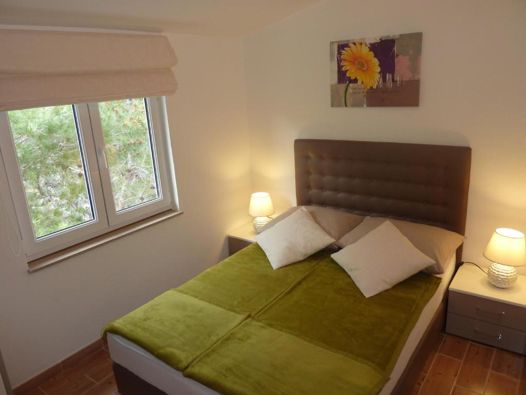 Postel nebo postele na pokoji v ubytování Apartments Ori