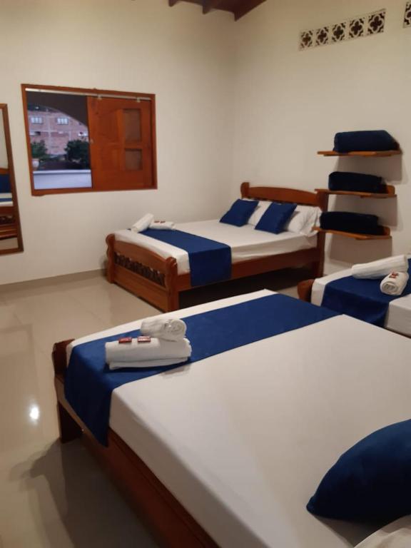 Postel nebo postele na pokoji v ubytování Hotel Jardín de Rosas
