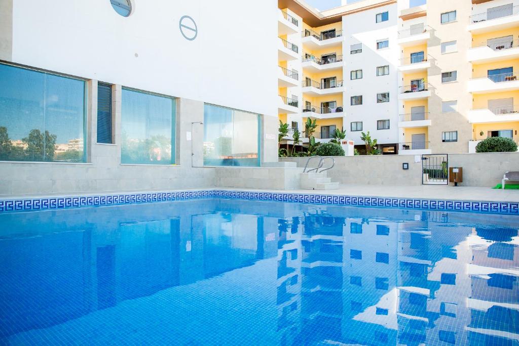 a swimming pool in front of a building at Lagos Central Wellness in Lagos