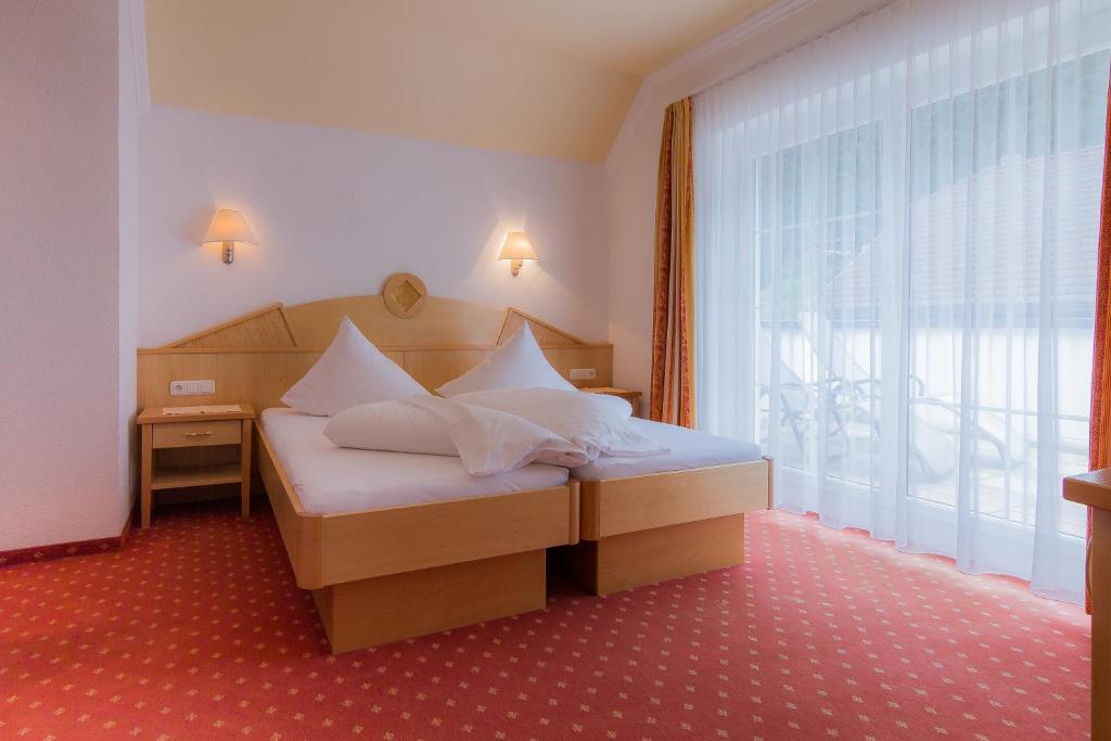 Posteľ alebo postele v izbe v ubytovaní Hotel Garni Martina