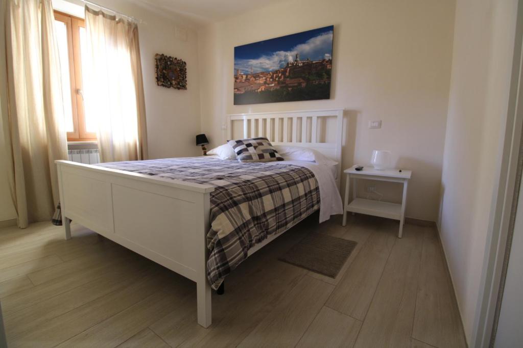 Un dormitorio con una cama con una manta. en Sei Unica en Siena