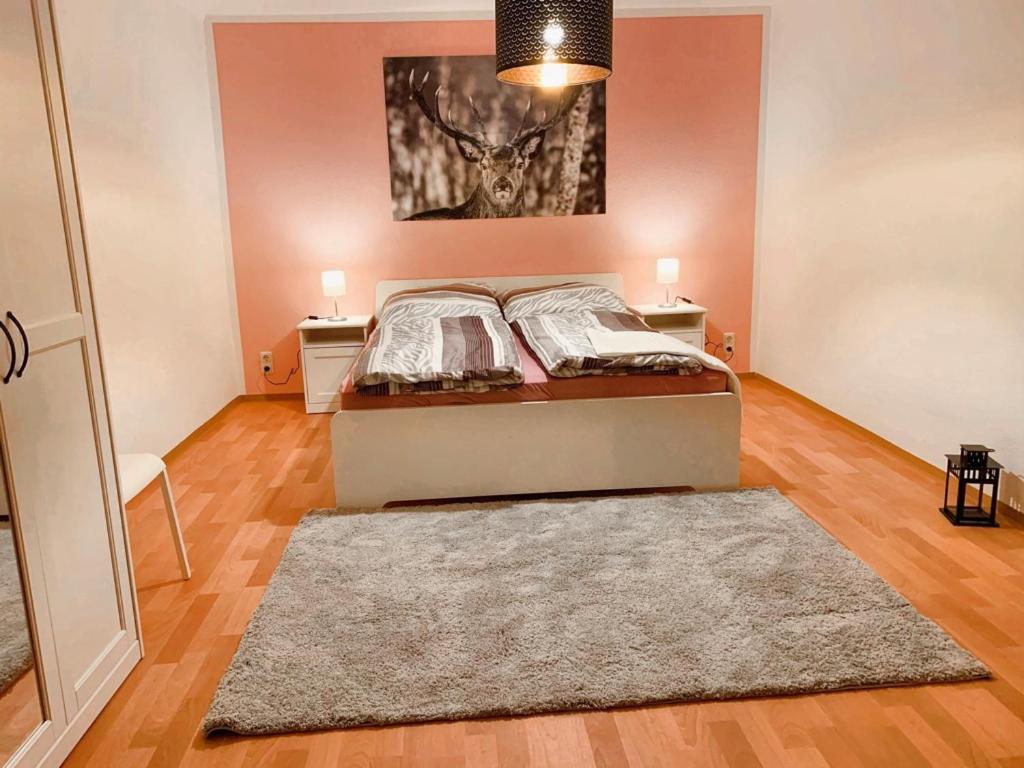 a bedroom with a bed and two tables and a rug at Klosterstraße 3 in Annaberg-Buchholz