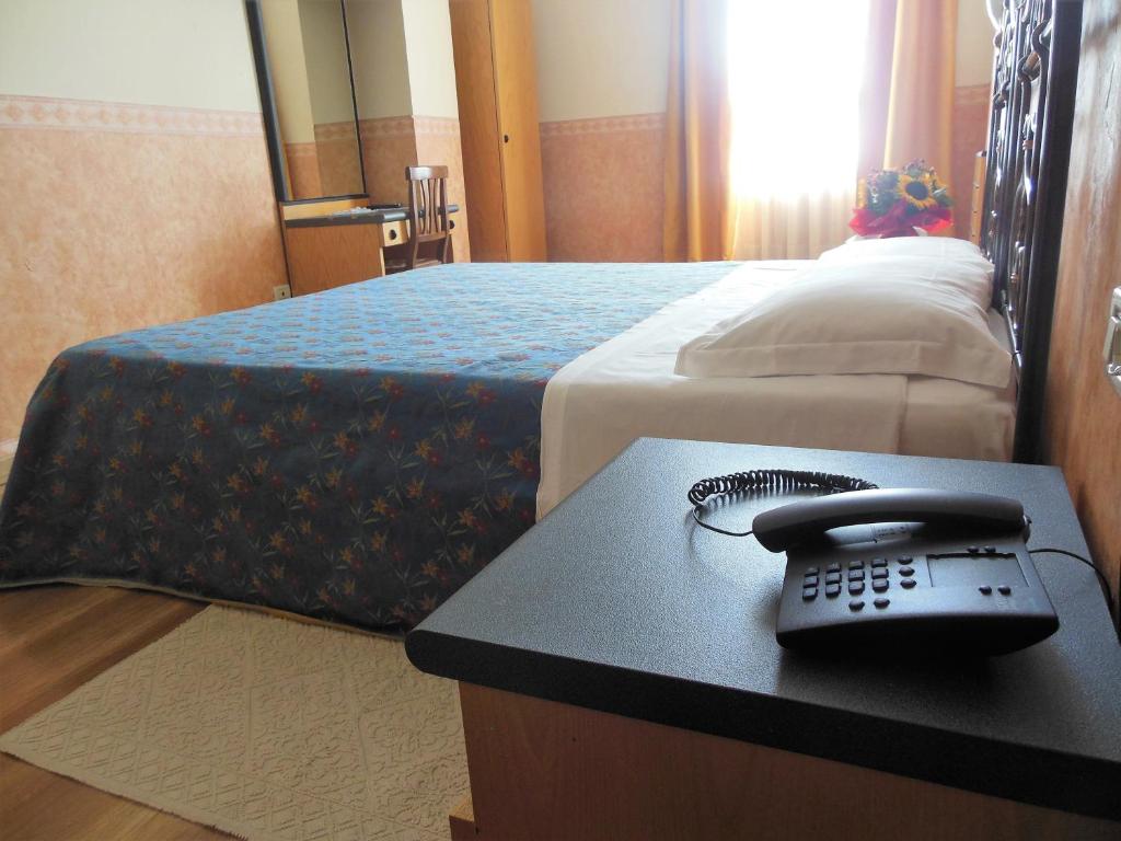 A bed or beds in a room at Hotel San Giorgio
