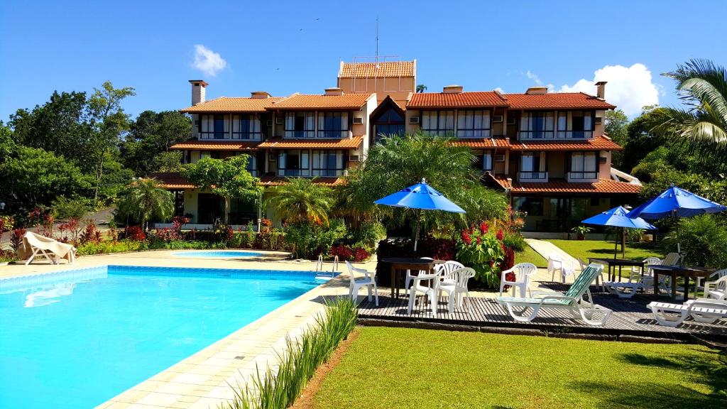 a resort with a swimming pool and a building at Ilha da Galé Tourist Hotel Fazenda de Bombas in Bombinhas