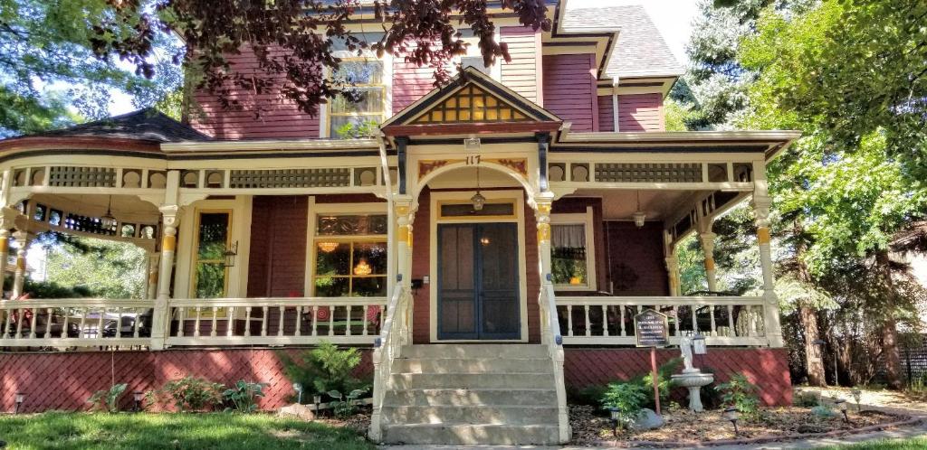an old house with a porch and a front door at Historic Victorian Inn in Sioux Falls