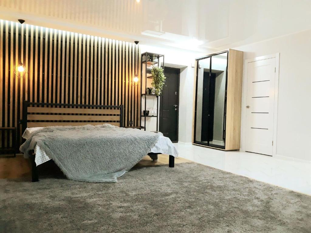 a bedroom with a bed and a mirror at Apartment on Karla Marksa Avenue in Kryvyi Rih