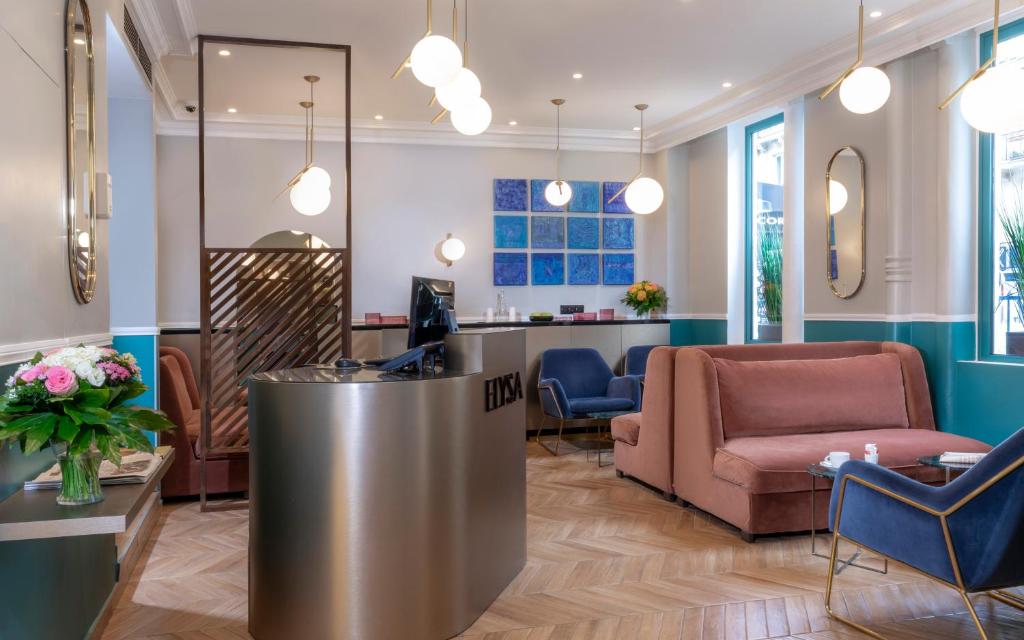 a lobby with a reception desk and chairs at Hotel Elysa-Luxembourg in Paris